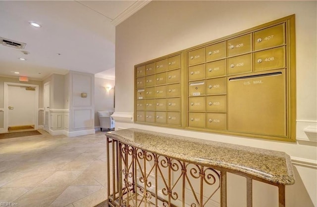 hallway featuring crown molding, mail boxes, and light tile patterned floors