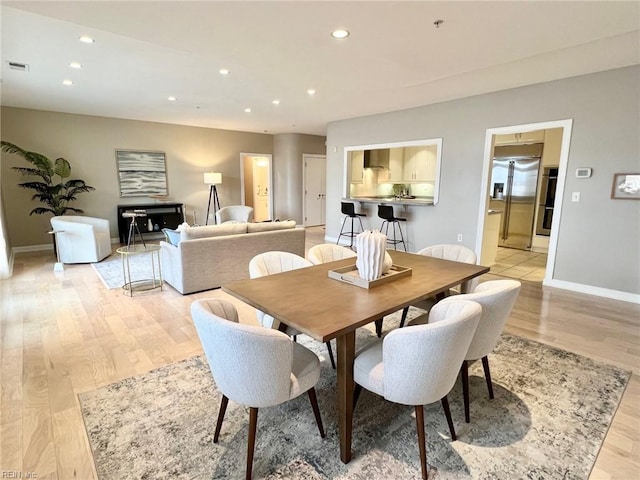 dining area with light hardwood / wood-style floors