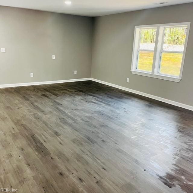 empty room with dark hardwood / wood-style floors