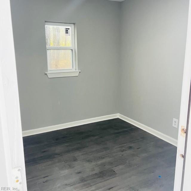 empty room with dark wood-type flooring