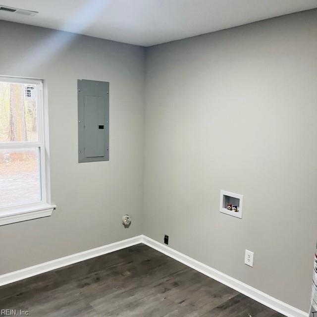 clothes washing area with washer hookup, dark hardwood / wood-style flooring, and electric panel