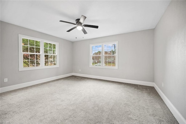 carpeted spare room with ceiling fan