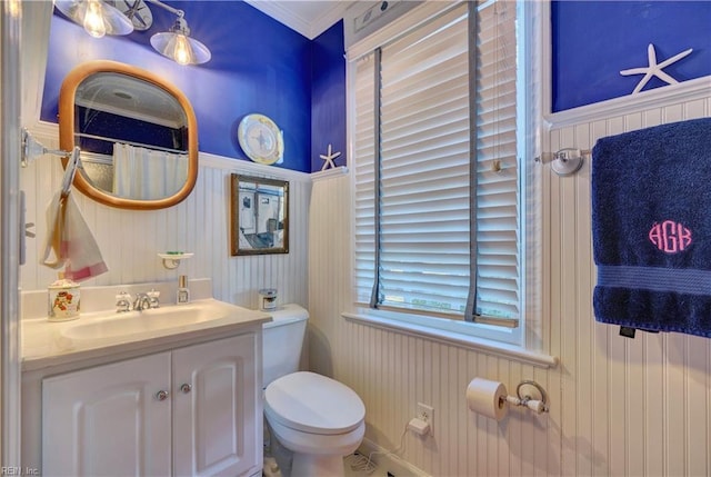 bathroom featuring vanity, toilet, and crown molding