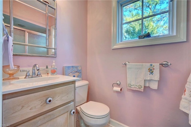 bathroom featuring vanity and toilet