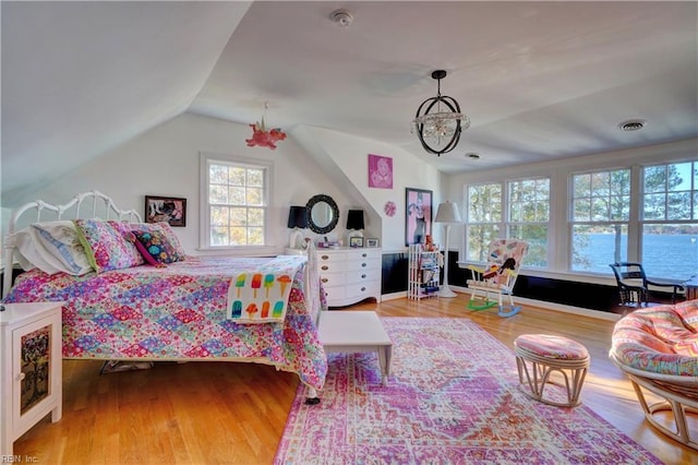 bedroom featuring hardwood / wood-style floors and vaulted ceiling