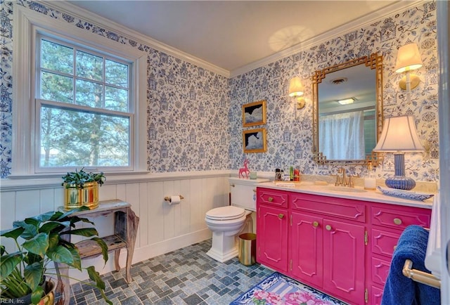 bathroom featuring crown molding, vanity, a healthy amount of sunlight, and toilet