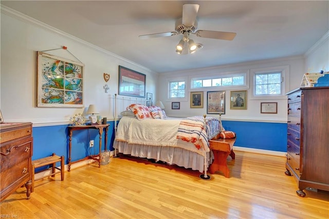 bedroom with ceiling fan, light wood-type flooring, ornamental molding, and multiple windows