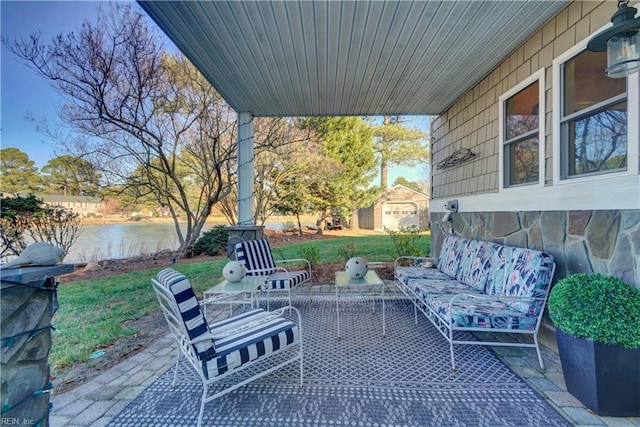 view of patio featuring an outdoor living space and a water view