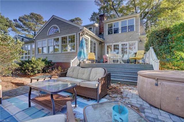 back of house with outdoor lounge area and a patio area