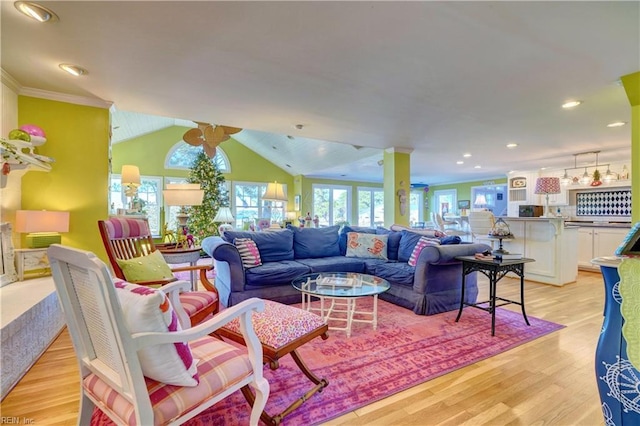 living room featuring lofted ceiling, crown molding, and light hardwood / wood-style flooring