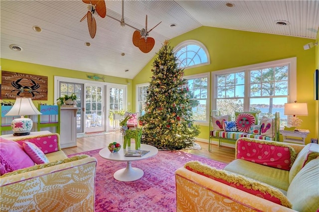 living room featuring light wood-type flooring, ceiling fan, and lofted ceiling