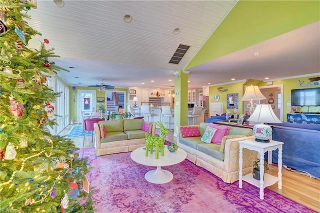 interior space with hardwood / wood-style flooring, vaulted ceiling, ceiling fan, and crown molding