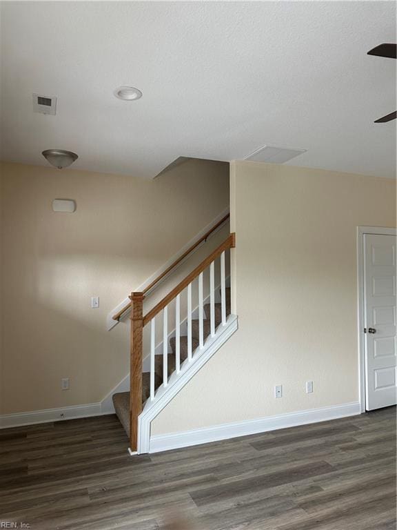 staircase with hardwood / wood-style flooring