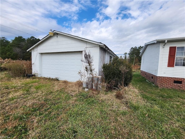 view of side of home with a garage and an outdoor structure