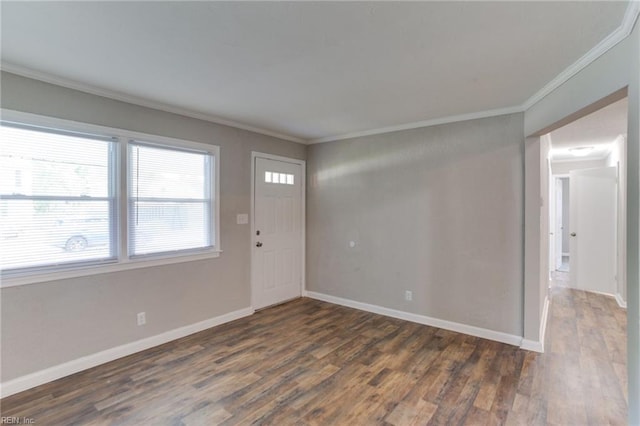 entrance foyer with dark hardwood / wood-style floors and ornamental molding