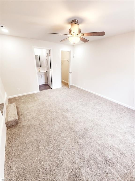 interior space with ceiling fan and carpet