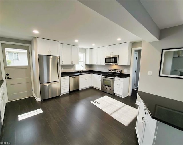 kitchen with white cabinetry, sink, and stainless steel appliances