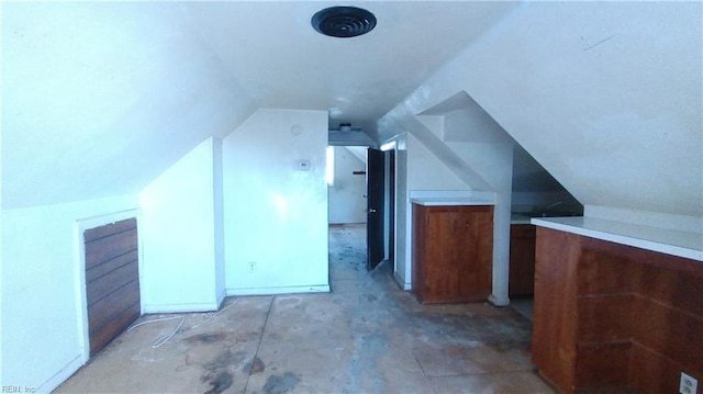 additional living space featuring lofted ceiling