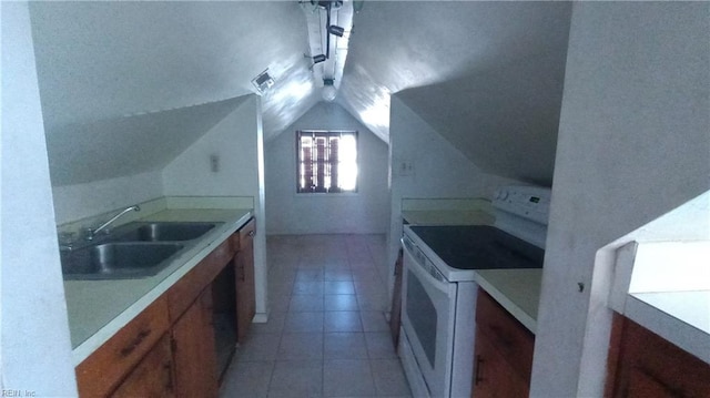 kitchen with electric range, light tile patterned flooring, lofted ceiling, and sink