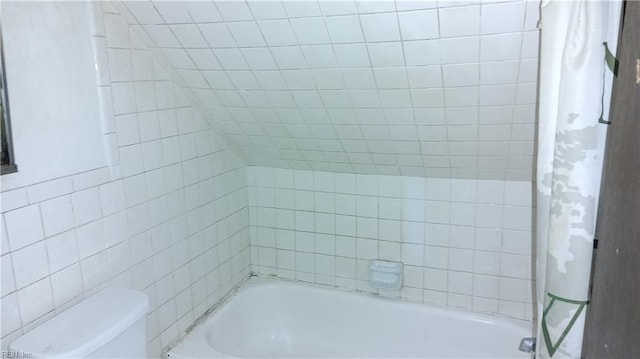 bathroom with toilet and shower / tub combo