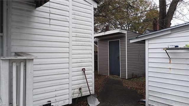 view of property exterior with a storage unit