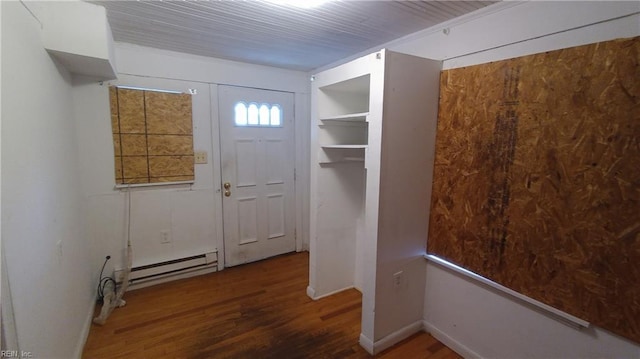 doorway to outside with dark hardwood / wood-style flooring and a baseboard heating unit