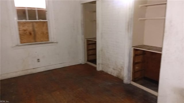 walk in closet with dark wood-type flooring