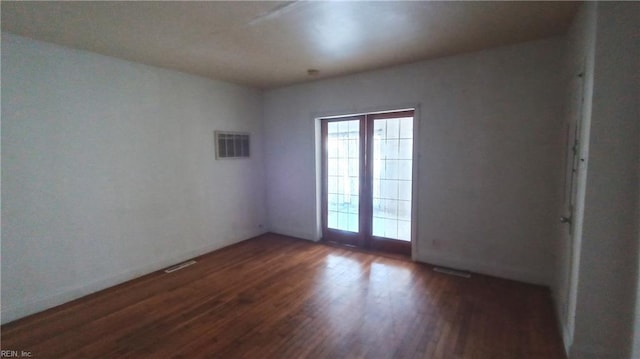 spare room featuring dark hardwood / wood-style flooring