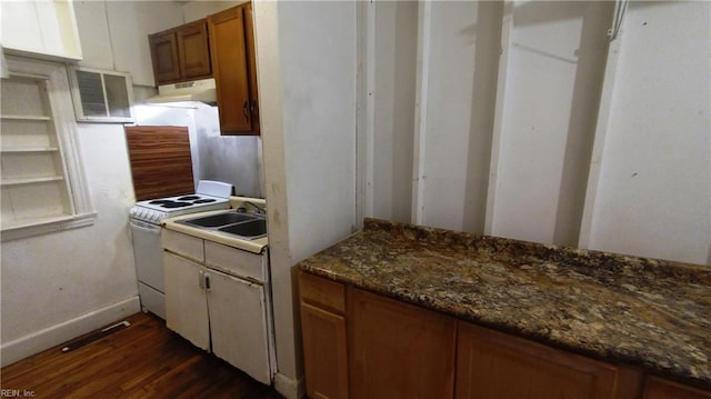 kitchen featuring sink, dark hardwood / wood-style flooring, white electric range, and dark stone countertops