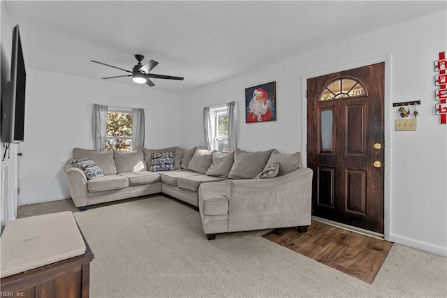 carpeted living room featuring ceiling fan