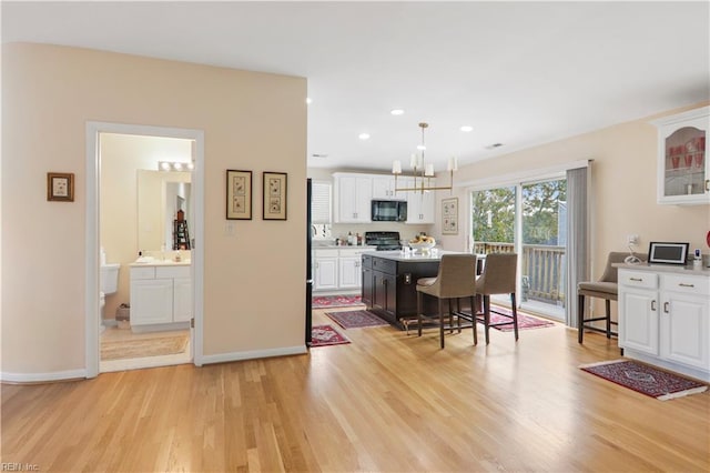 dining room with light hardwood / wood-style floors and a chandelier