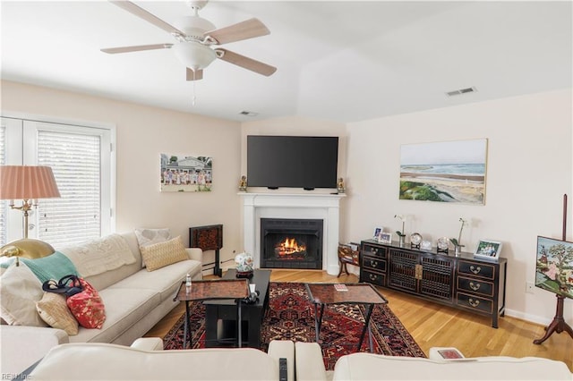 living room with ceiling fan and light wood-type flooring