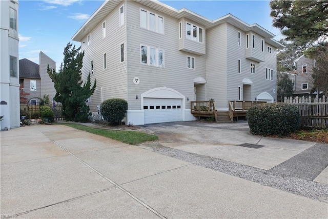 view of front of property featuring a garage and a wooden deck