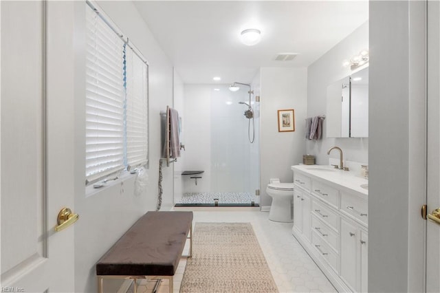 bathroom with vanity, toilet, and a shower with shower door