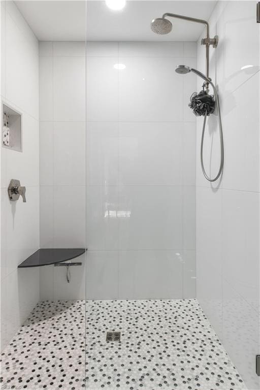 bathroom featuring a shower with door