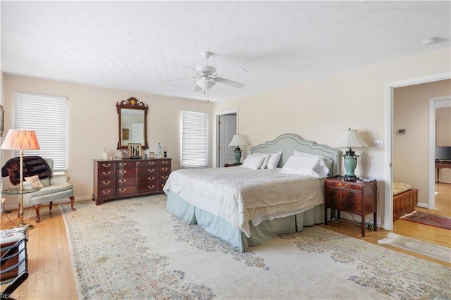 bedroom with ceiling fan and light wood-type flooring