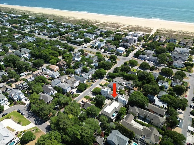 bird's eye view with a water view and a beach view