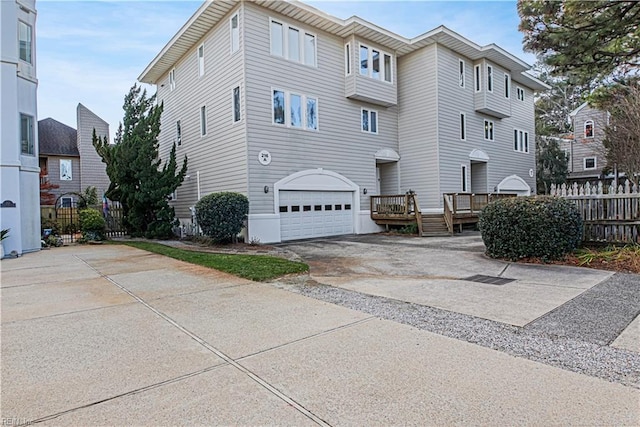 multi unit property featuring a garage and a deck