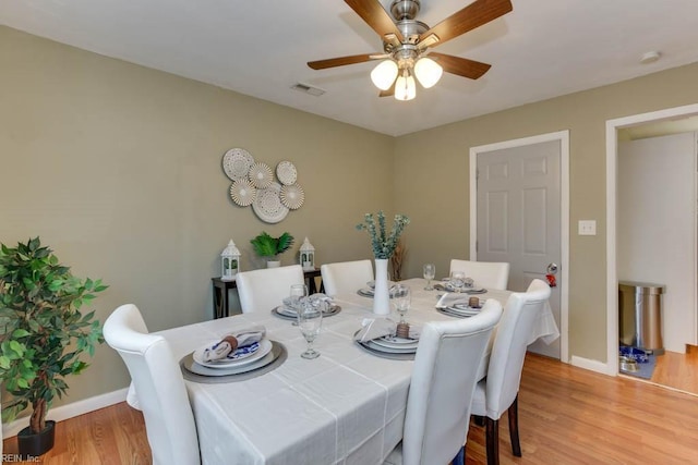 dining area with ceiling fan and light hardwood / wood-style floors