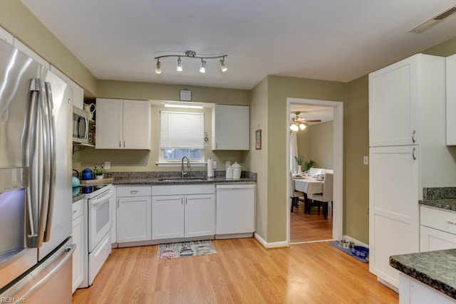 kitchen with ceiling fan, sink, appliances with stainless steel finishes, white cabinets, and light wood-type flooring