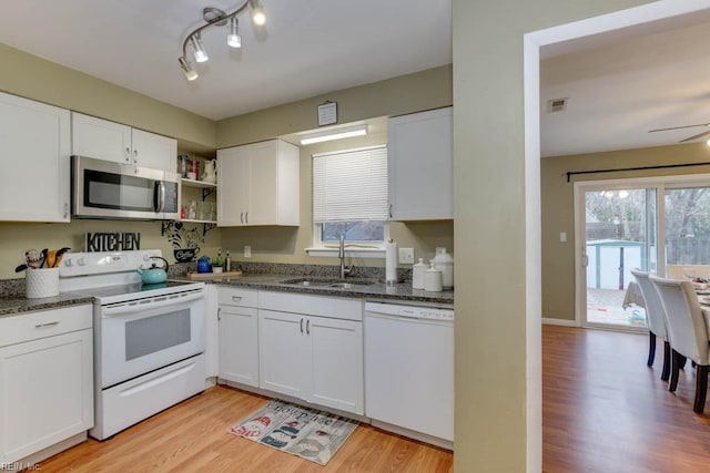 kitchen featuring white appliances, ceiling fan, sink, light hardwood / wood-style flooring, and white cabinets