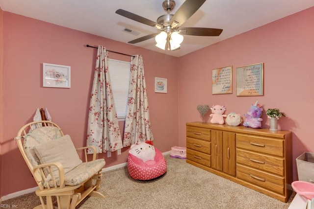 living area with carpet flooring and ceiling fan