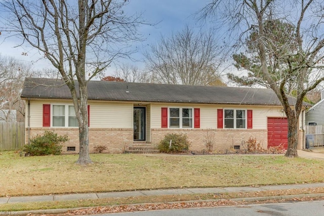 ranch-style home featuring a garage and a front lawn