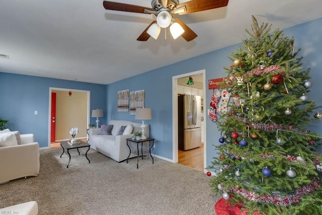 living room with ceiling fan and light colored carpet