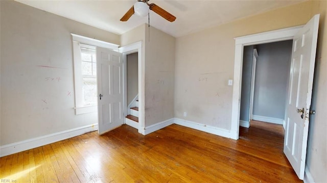 unfurnished bedroom with hardwood / wood-style floors and ceiling fan