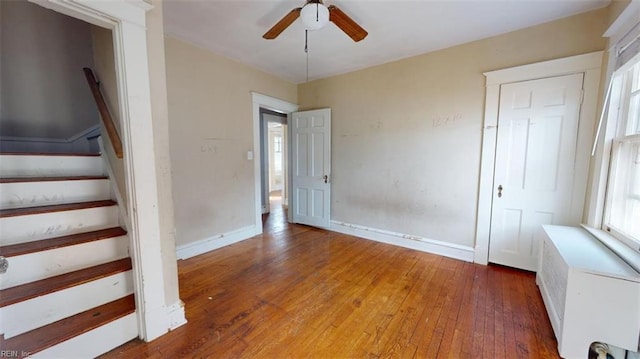 spare room featuring hardwood / wood-style floors, radiator heating unit, and ceiling fan