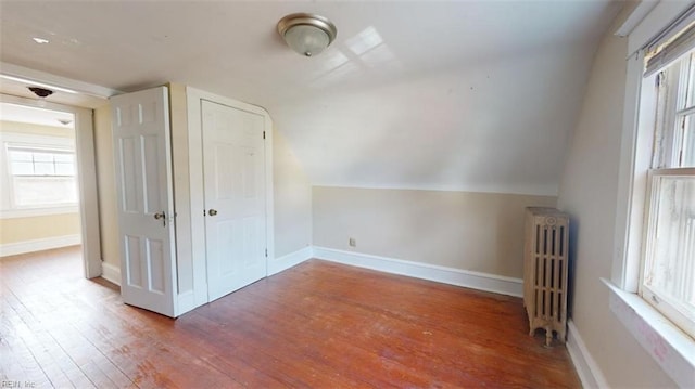 bonus room featuring radiator heating unit, lofted ceiling, and hardwood / wood-style flooring