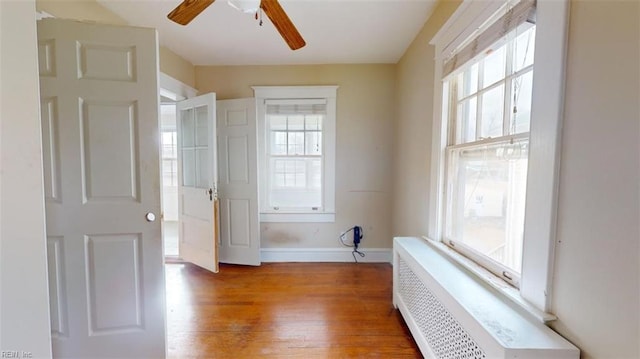 interior space with radiator and wood-type flooring