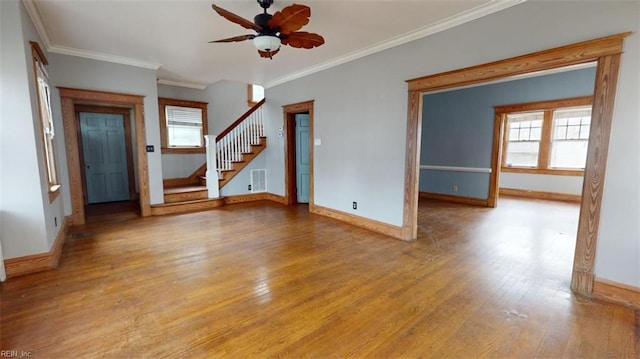 empty room with ceiling fan, light wood-type flooring, and ornamental molding