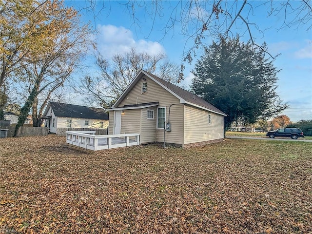 view of side of property featuring a wooden deck